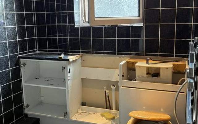 Unfinished Bathroom featuring a toilet, basin, and a storage cabinet