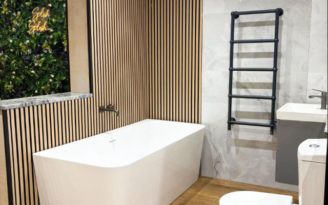 Interior view of a bathroom with a toilet, basin, and bathtub